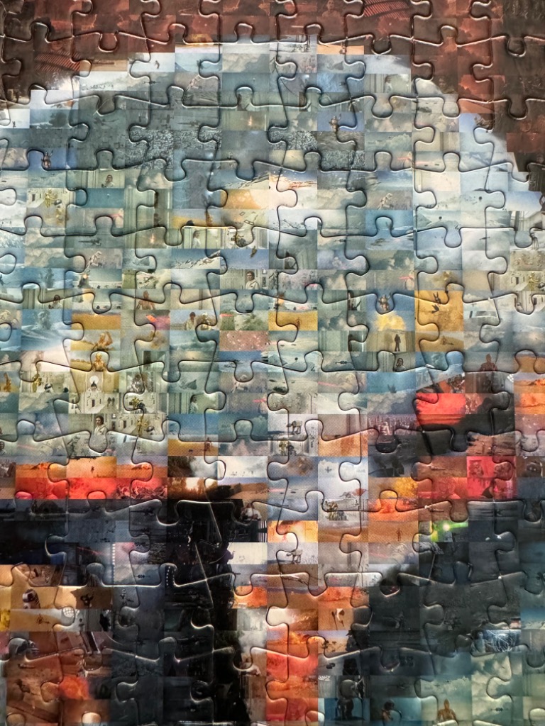 A montage of various Star Wars film scenes forming a large portrait of Darth Vader.