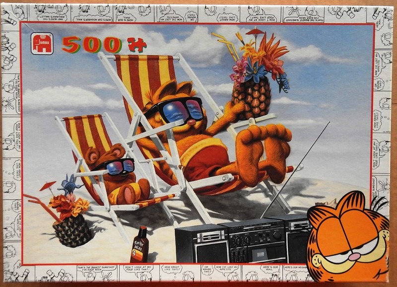 Garfield and Pooky lounging on beach chairs with pineapple drinks and a boombox