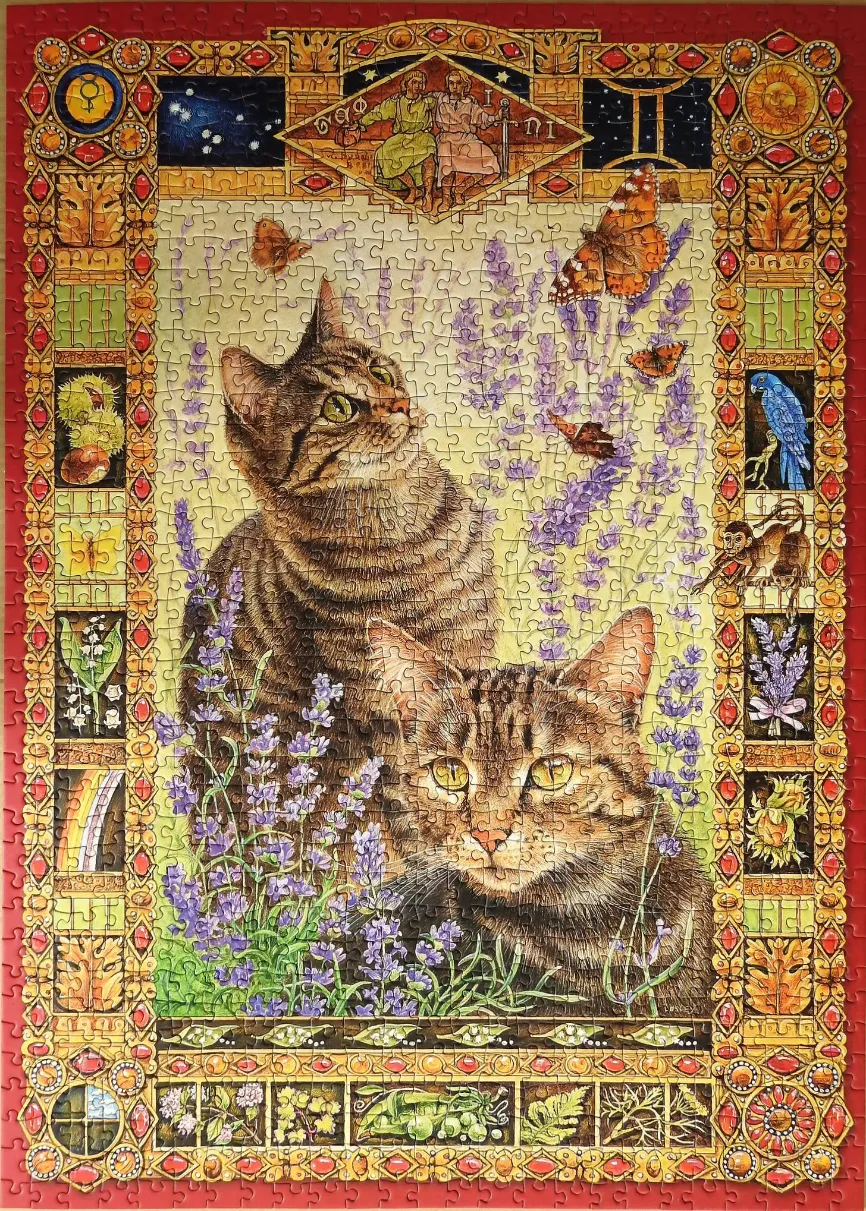 Two tabby cats sitting in a field of lavender framed by an ornate, astrological-themed gold border.