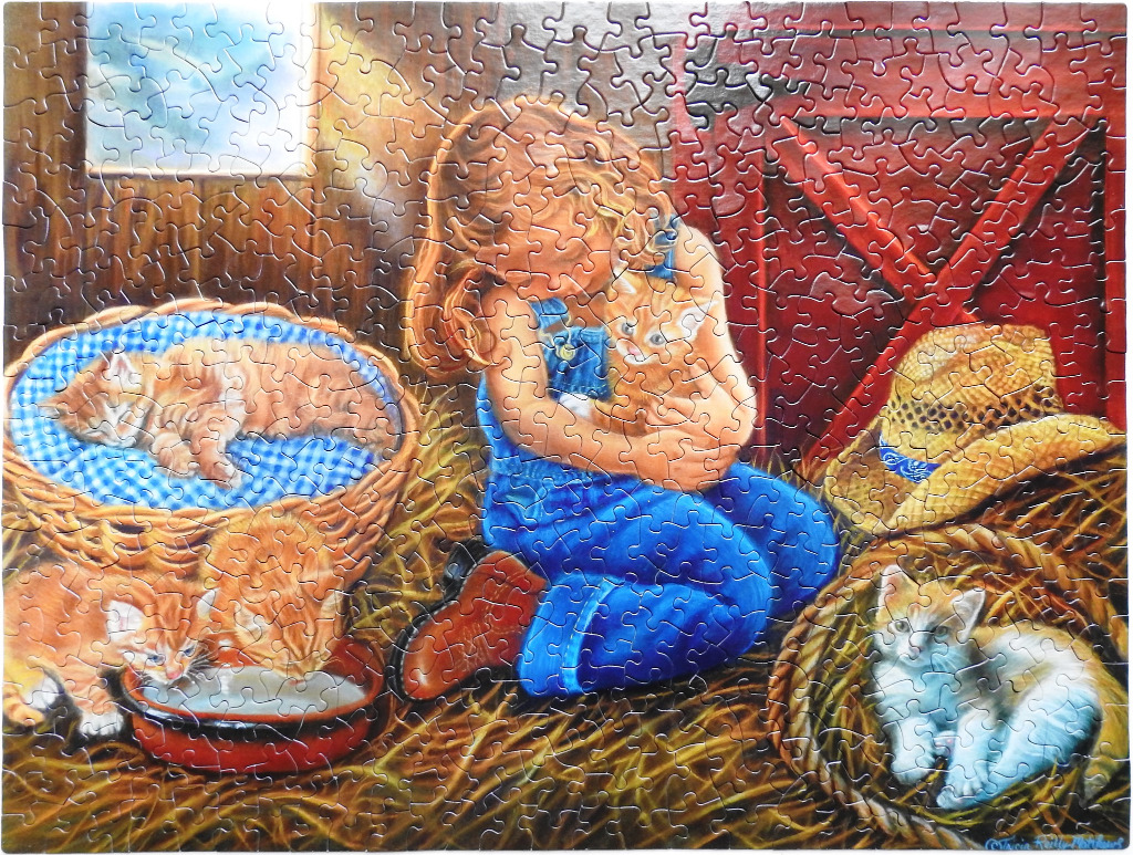 A young girl with long blonde hair hugs an orange kitten inside a rustic barn filled with hay and cats.