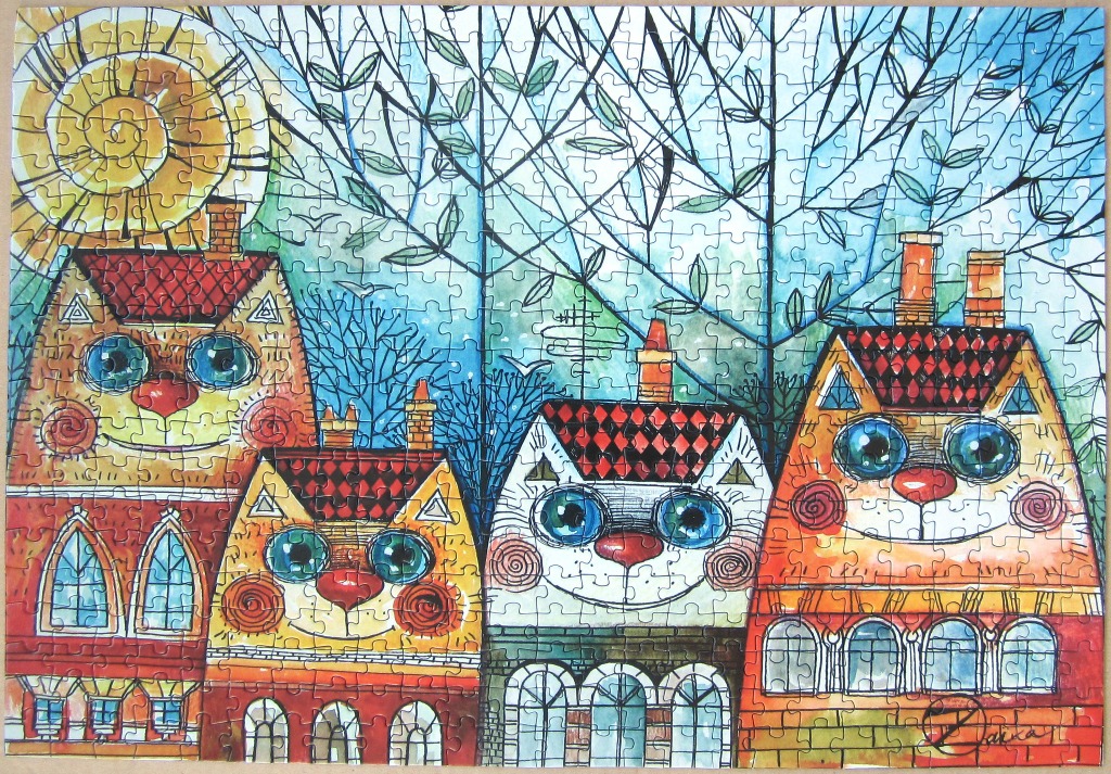 Whimsical illustration of four cat-shaped houses standing together in a row beneath a stylized sun.