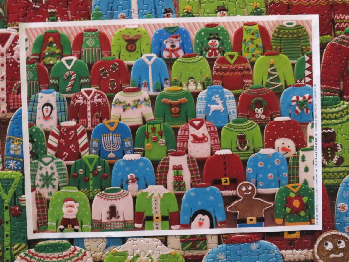 A collection of colorful gingerbread sweaters with various festive holiday designs.