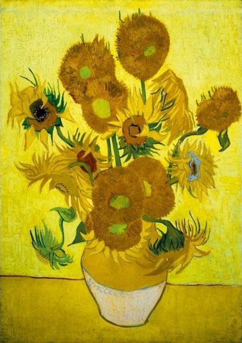 A vase of sunflowers in various stages of bloom against a vibrant yellow background.