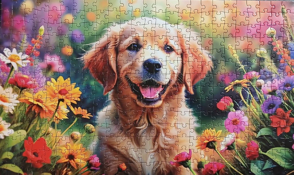 A golden retriever puppy sitting in a vibrant field of colorful wildflowers.