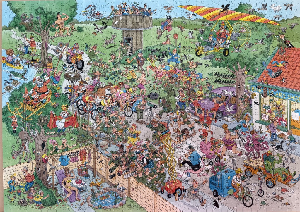 A chaotic, humorous cartoon scene filled with many birdwatchers and varied characters in a park setting.