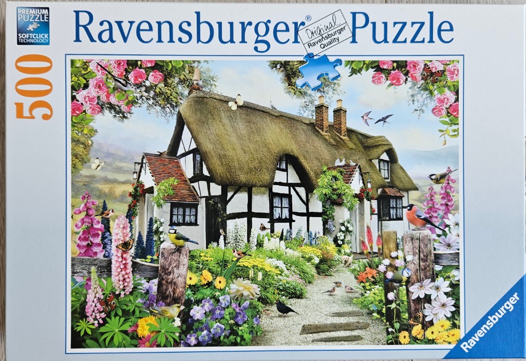 A charming English thatched cottage garden filled with flowers and wild birds.