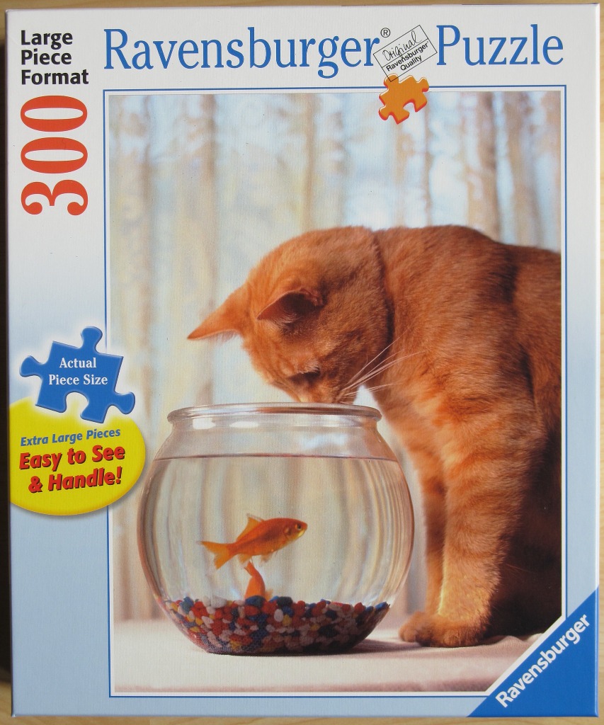 An orange tabby cat peering curiously at a goldfish in a glass bowl.