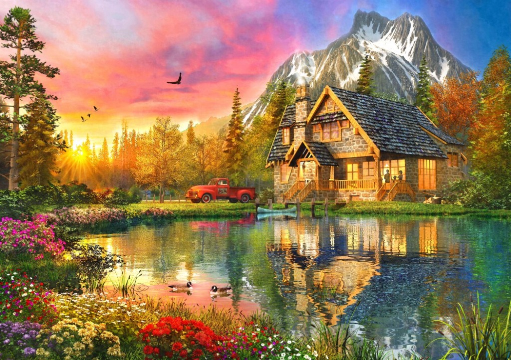 A cozy stone cabin by a lake at sunset with a red truck and snow-capped mountains in the background