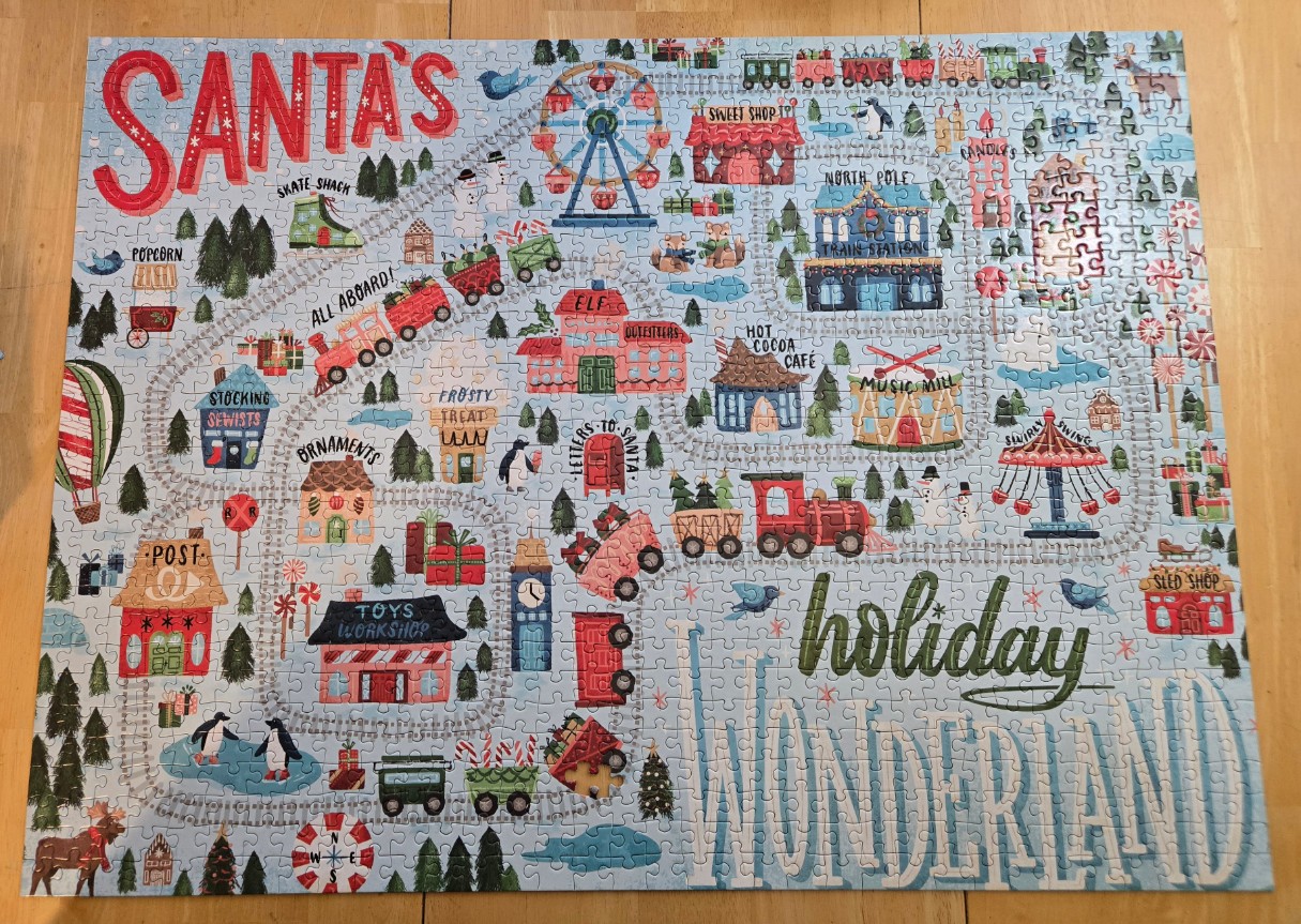 Illustrated map of Santa's holiday wonderland with trains, shops, and amusements.