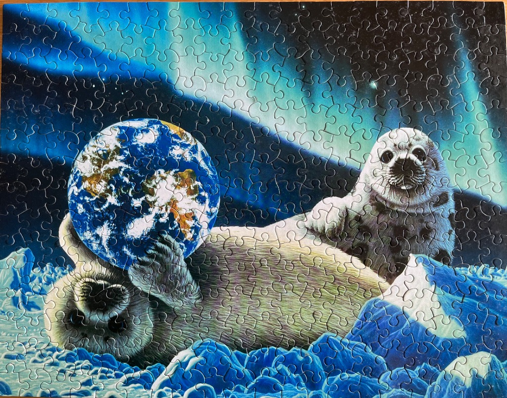 A harp seal pup holding a globe against a backdrop of the aurora borealis.