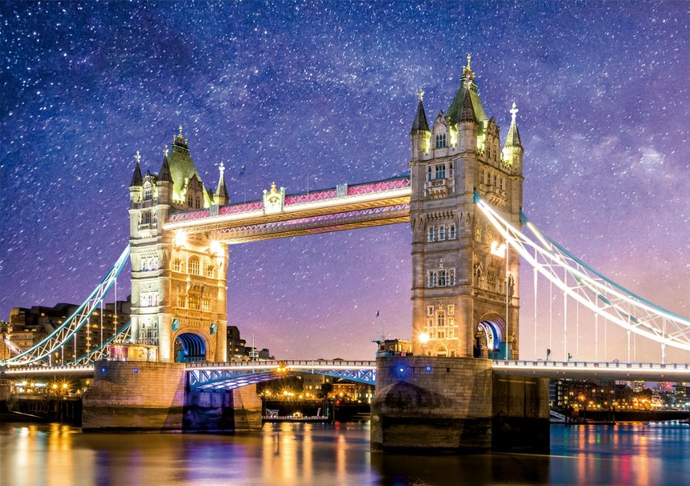 Tower Bridge in London illuminated at night under a vibrant starry sky.