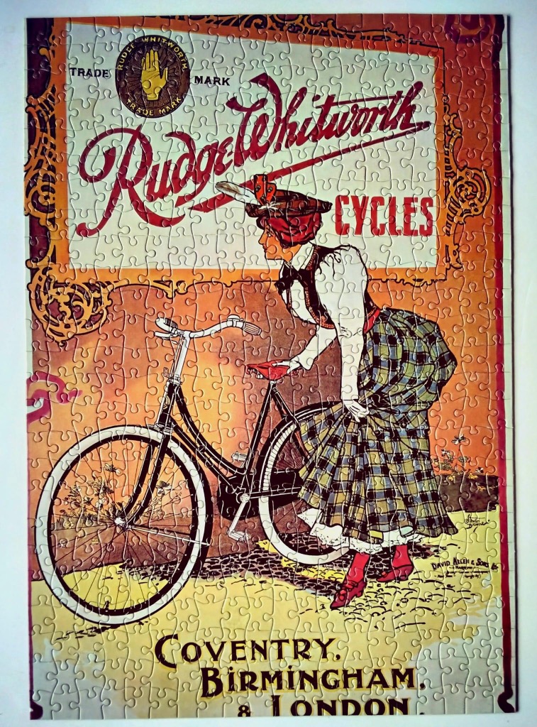Vintage Rudge-Whitworth Cycles advertisement poster featuring a woman in a plaid skirt with a bicycle.