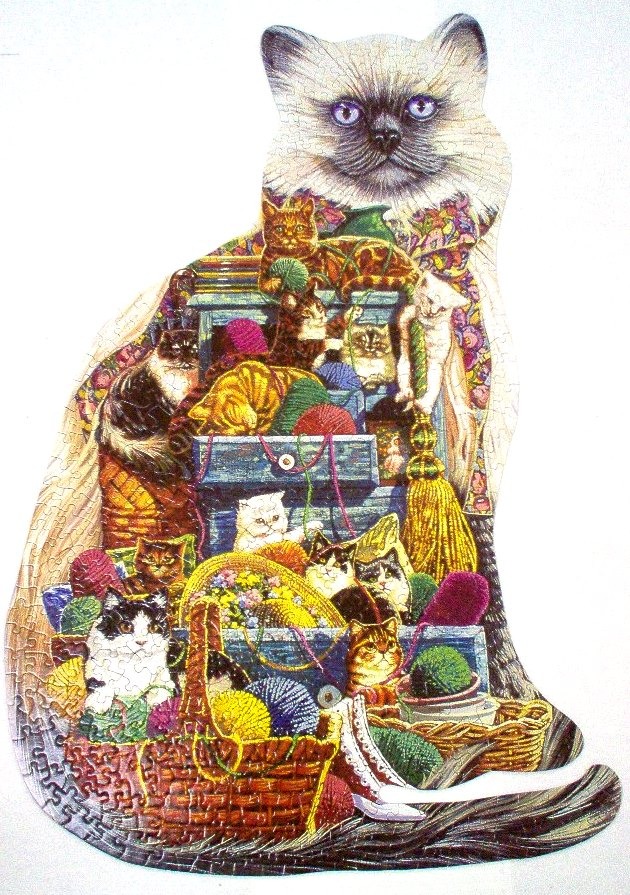 A whimsical shaped image of a large cat composed of many smaller cats and balls of yarn.