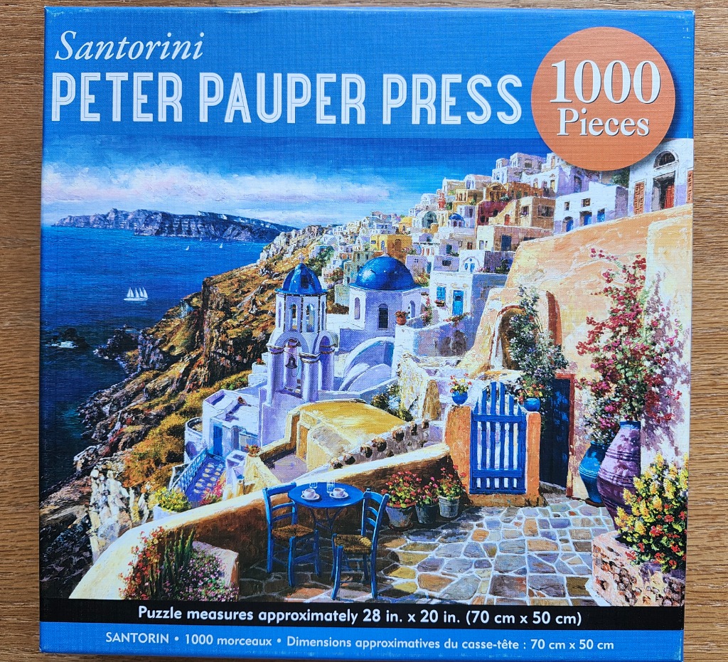 A panoramic oil painting of the Santorini coastline featuring blue-domed churches and a patio overlook.