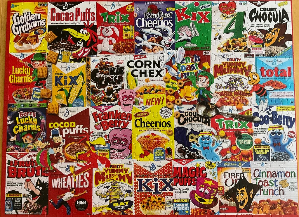 A collage of vintage breakfast cereal boxes featuring colorful cartoon mascots and brand names.
