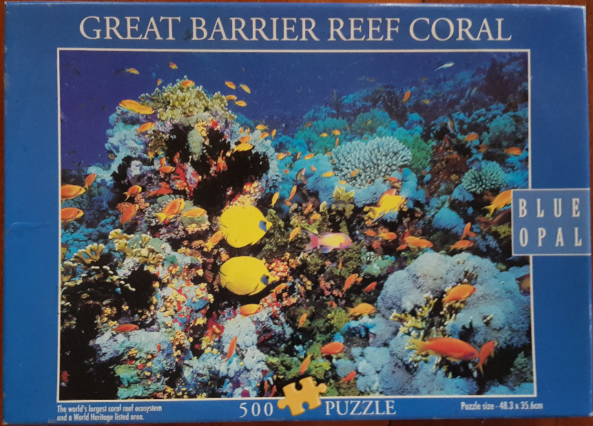 Vibrant underwater scene of the Great Barrier Reef featuring bright yellow and orange tropical fish among colorful coral.