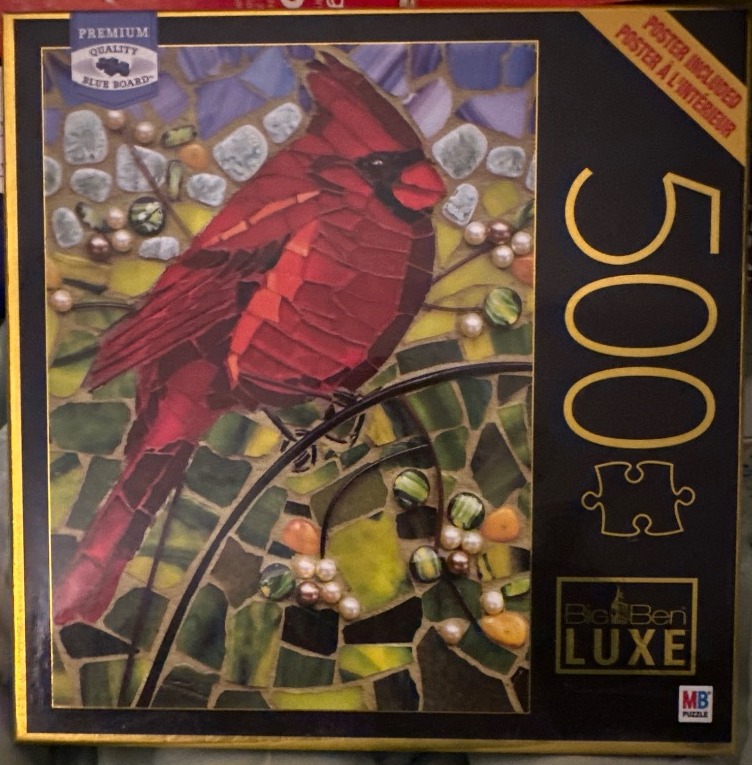 A mosaic art style image of a bright red cardinal perched on a branch, set against a background of colourful stones.