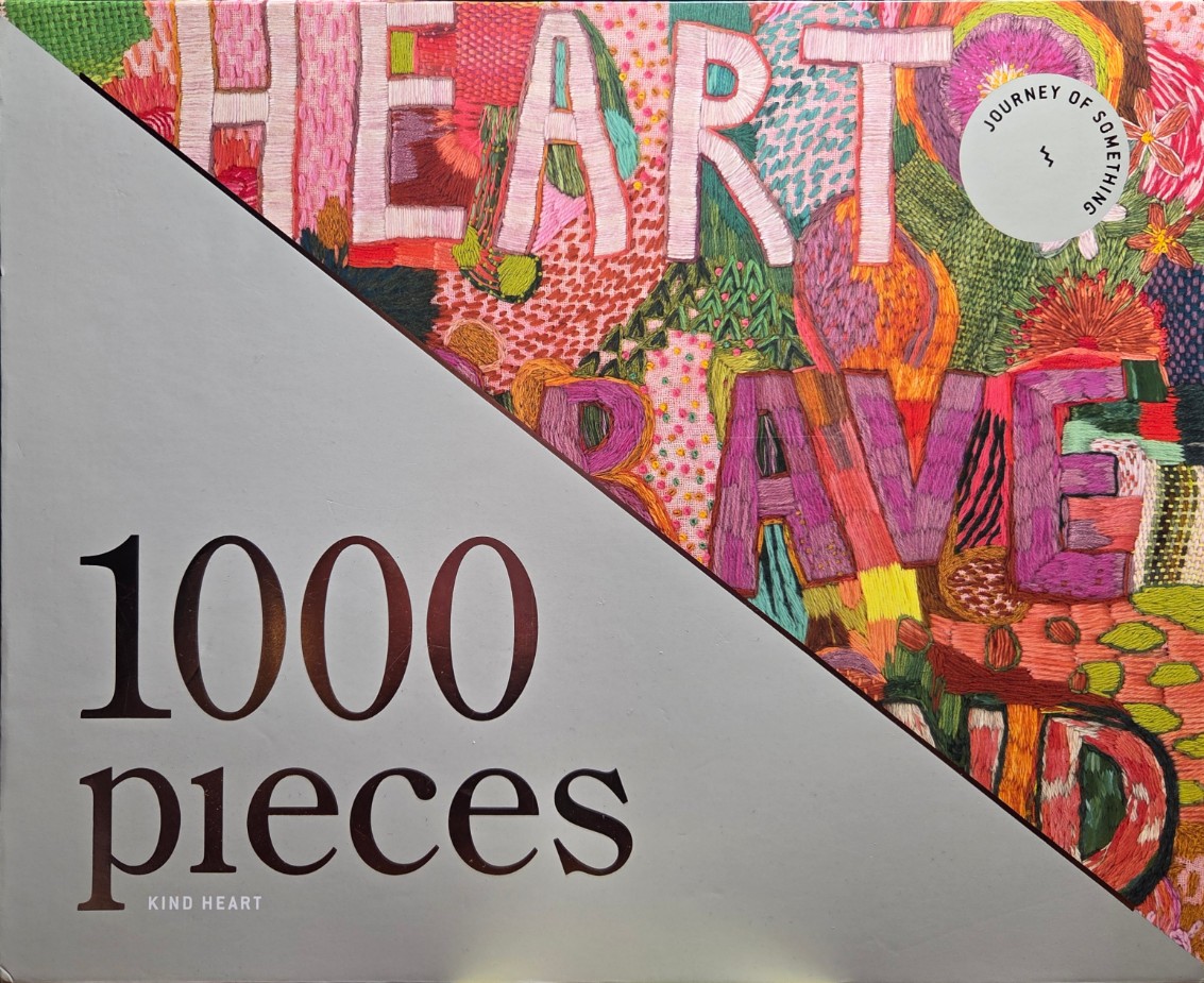 Colorful embroidered artwork reading HEART BRAVE, split diagonally by a grey section.