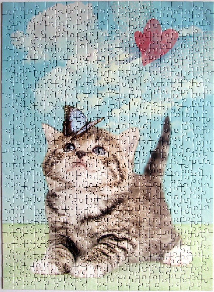 A cute tabby kitten looking up at a butterfly in a bright, sky-themed fantasy setting.