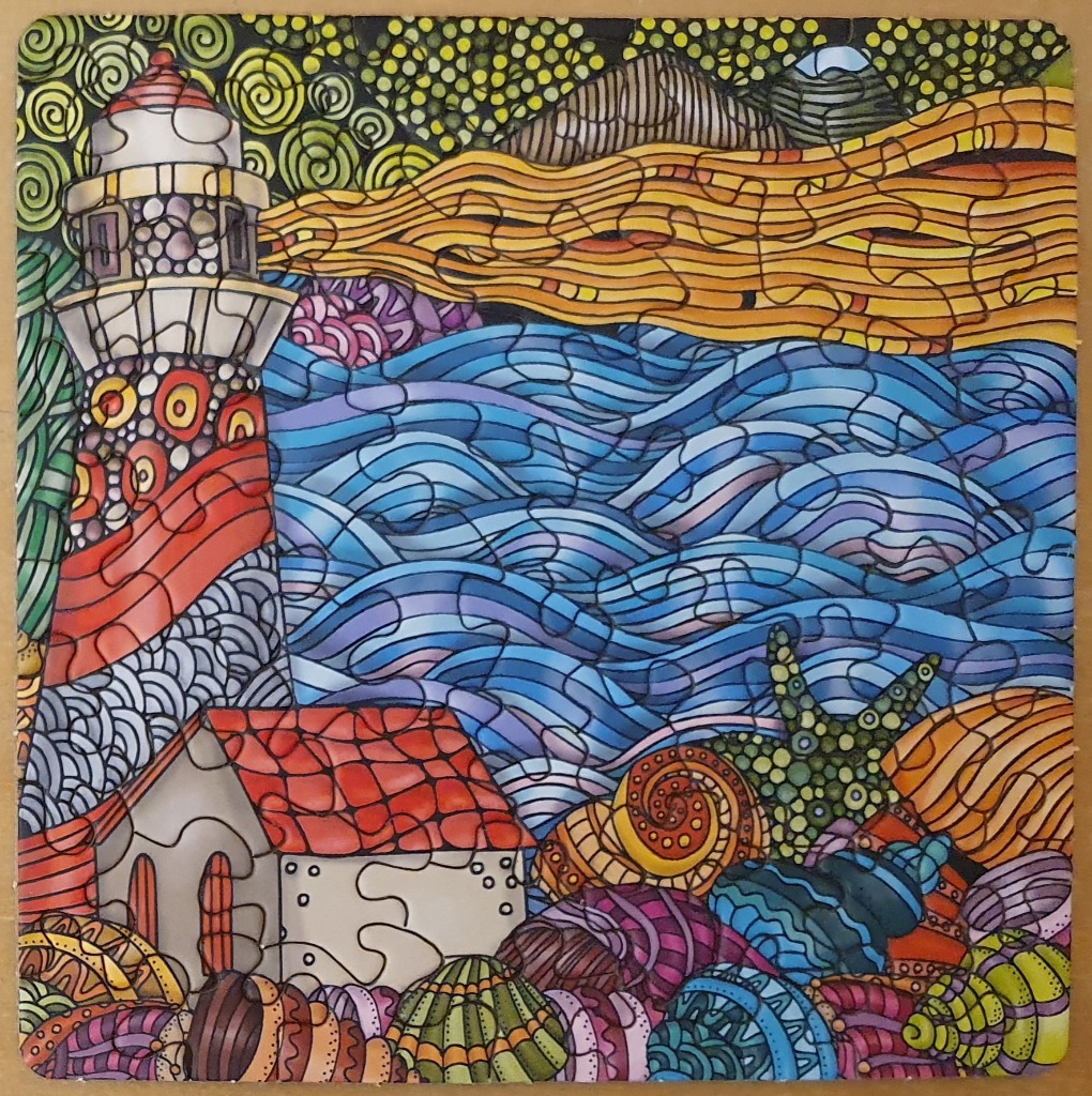 A whimsical, colourful illustration of a lighthouse by the sea, featuring patterned seashells in the foreground.