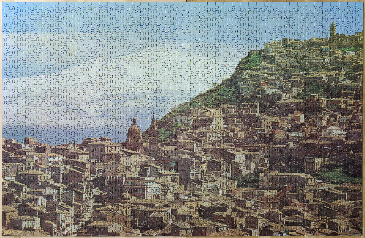 A panoramic illustration of a densely packed hillside Mediterranean town under a bright blue sky.