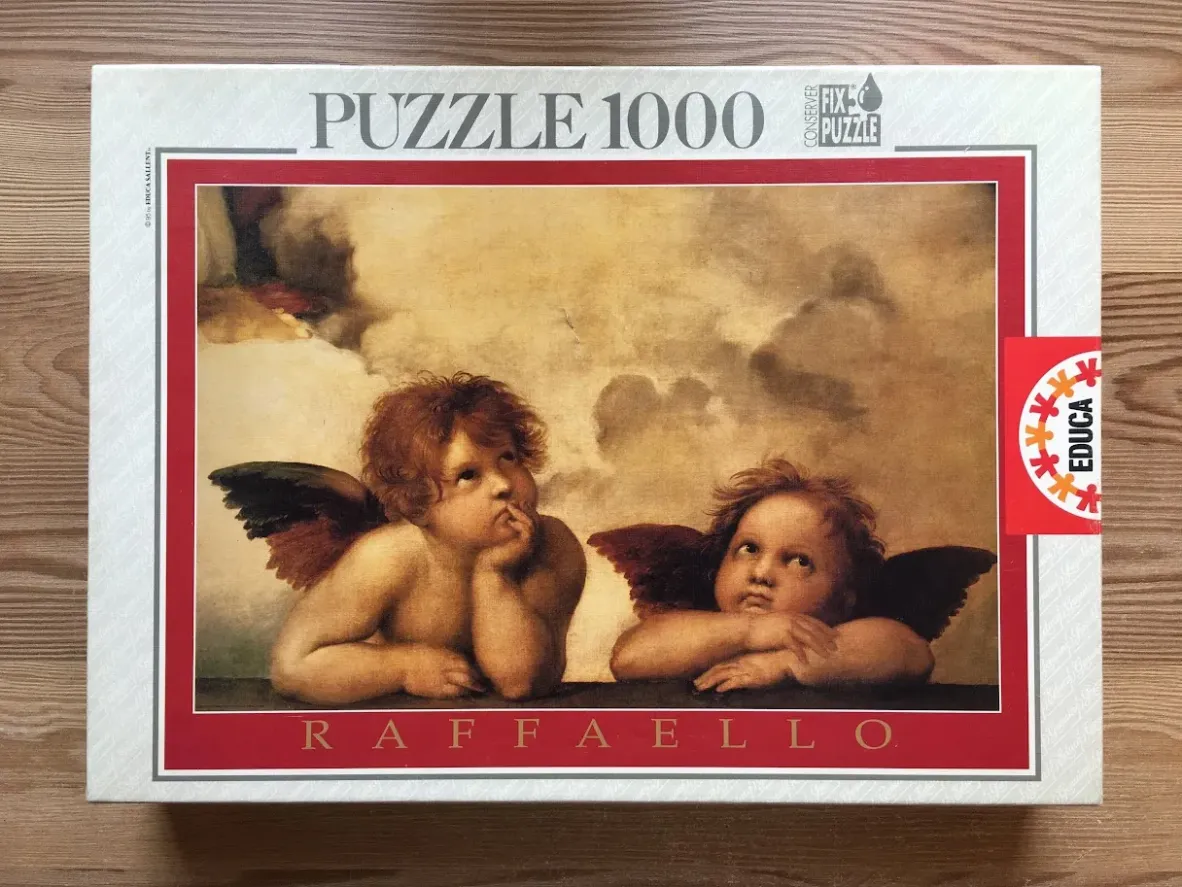 A famous Renaissance painting featuring two contemplative cherubs resting their chins on their hands.