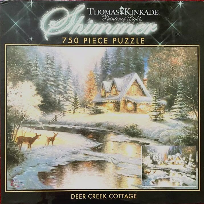 A snow-covered stone cottage with a glowing interior sits by a stream as two deer stand on the bank in a winter forest.