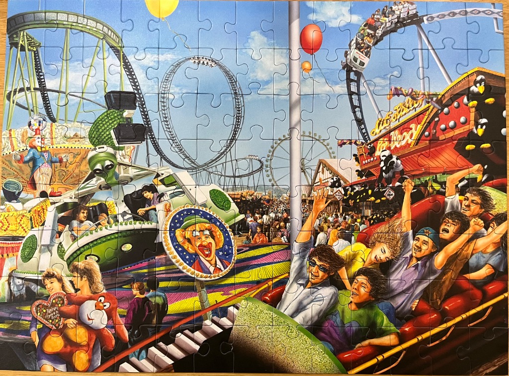 A bustling amusement park scene featuring roller coasters, carnival rides, and a crowd of excited people.