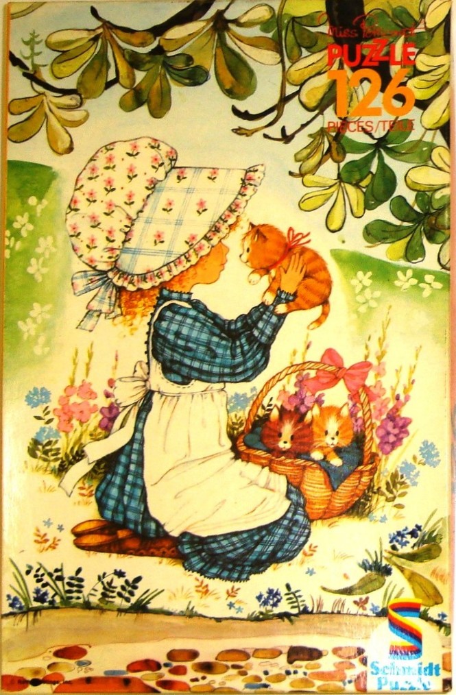 A young girl in a bonnet holding a kitten with a basket of other kittens in a garden setting.