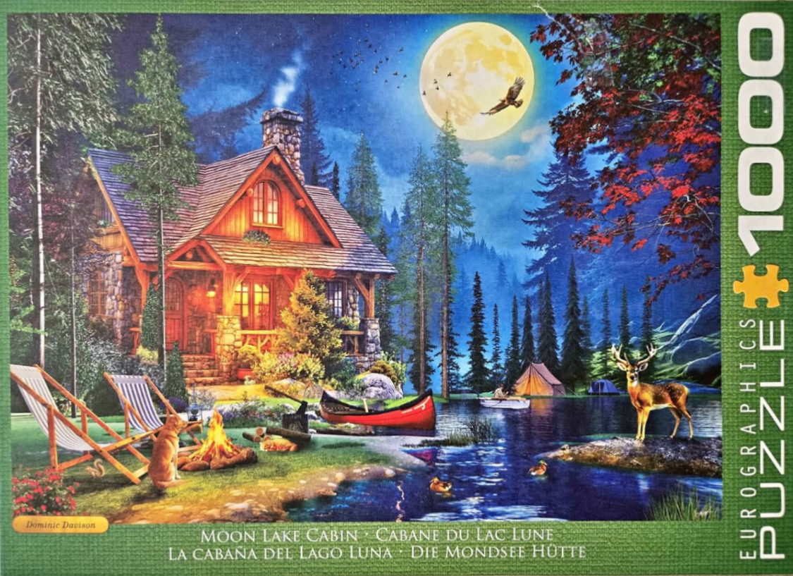 A cozy cabin at night by a lake under a full moon, with a campfire and a deer in the foreground.