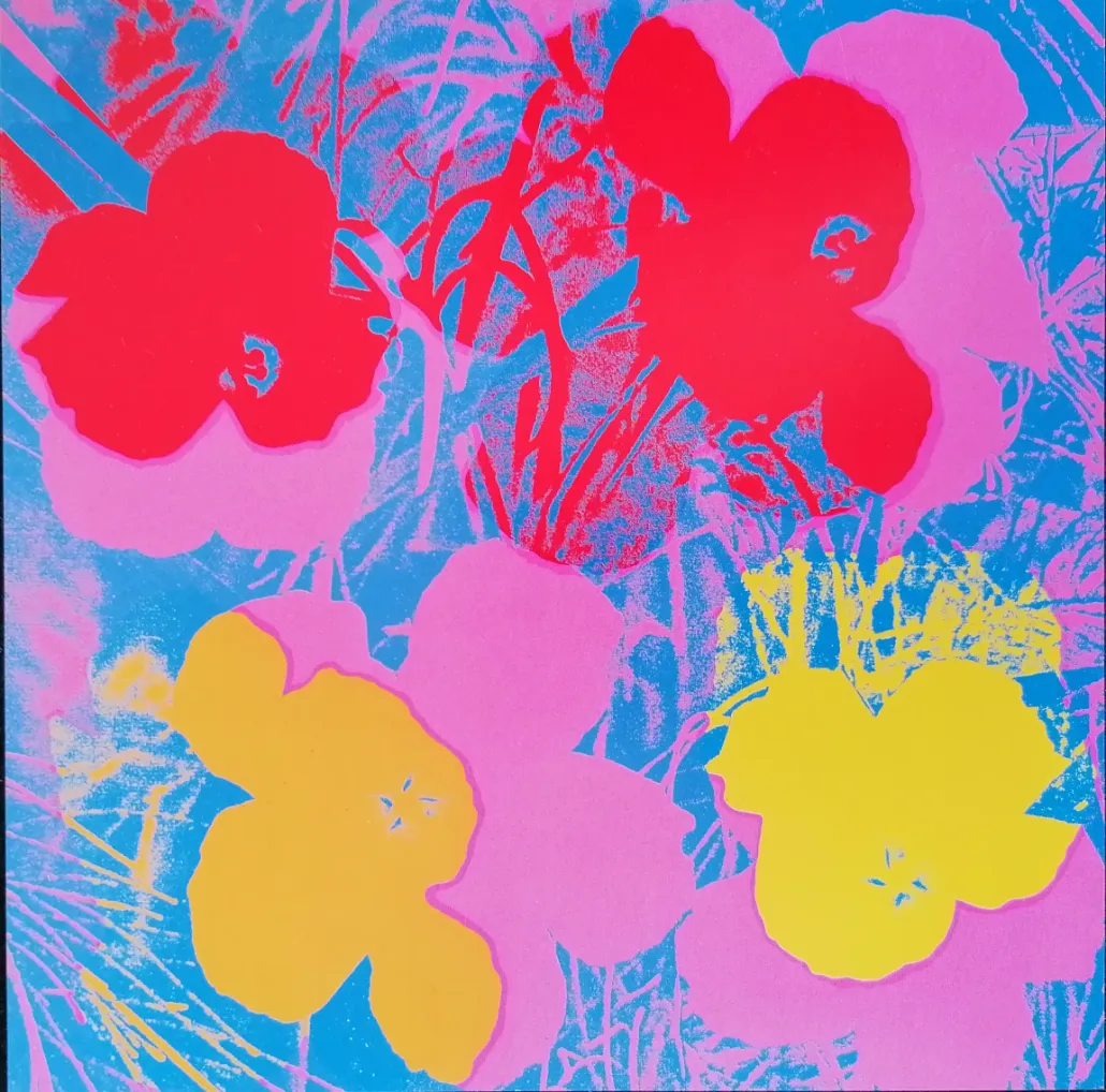Four stylized hibiscus-like flowers in vibrant red, yellow, and pink colors against a bright blue background.