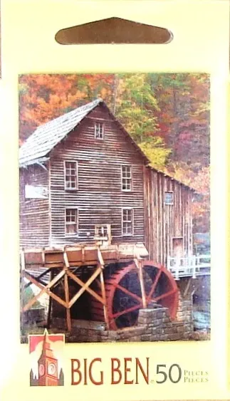 A rustic wooden water mill nestled in a vibrant autumn forest.