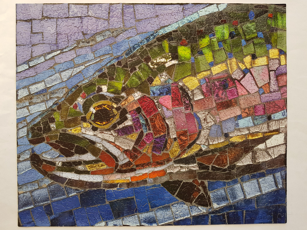 A close-up mosaic art piece of a rainbow trout swimming through water.