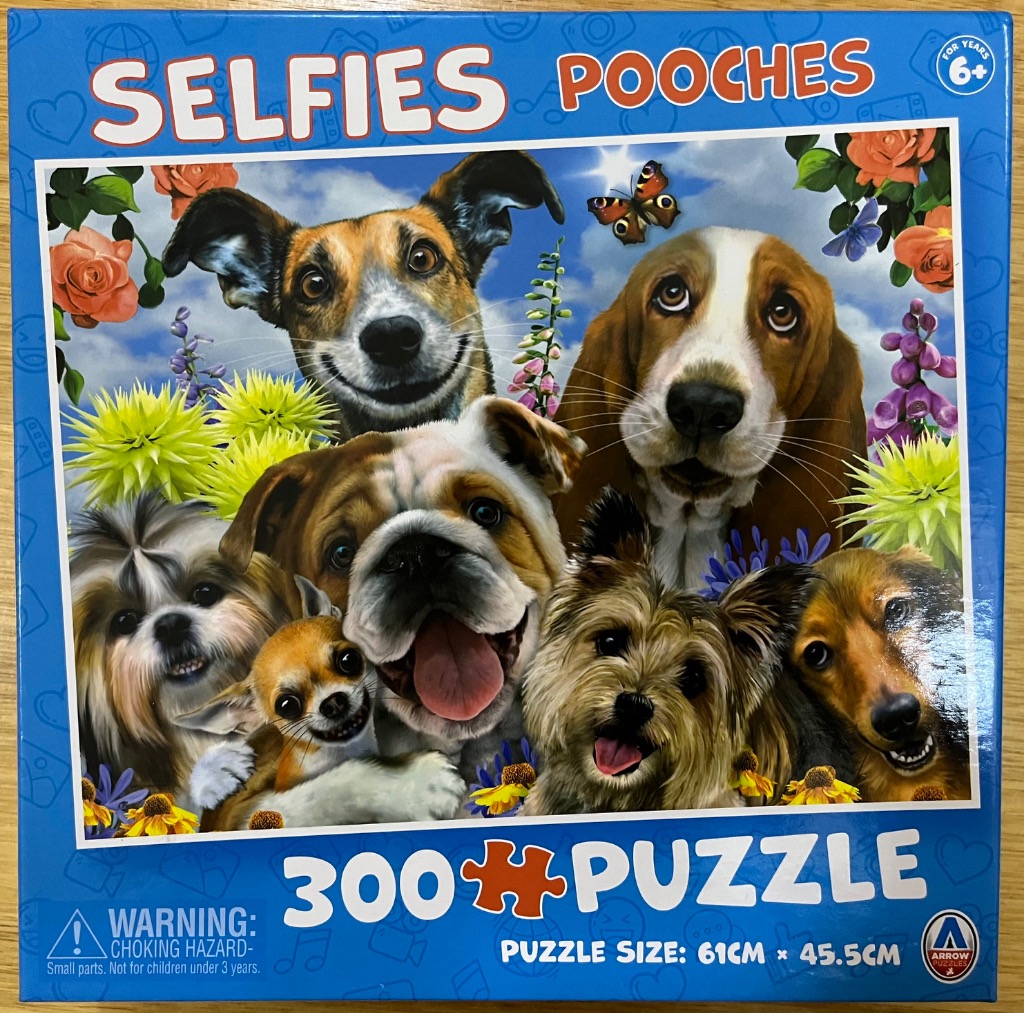 Close-up composite portrait of six diverse dog breeds posing for a selfie surrounded by flowers and a butterfly.