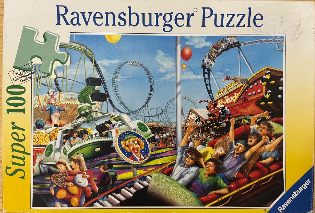 A busy carnival scene featuring a rollercoaster, spinning rides, and joyful crowds under a bright blue sky.