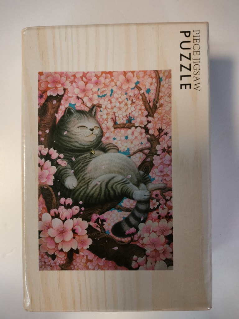 An illustration of a rotund, contented grey tabby cat napping in a cherry blossom tree.