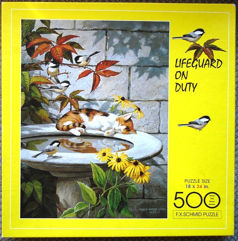 A calico cat sleeping on a stone birdbath surrounded by black-capped chickadees and yellow flowers.