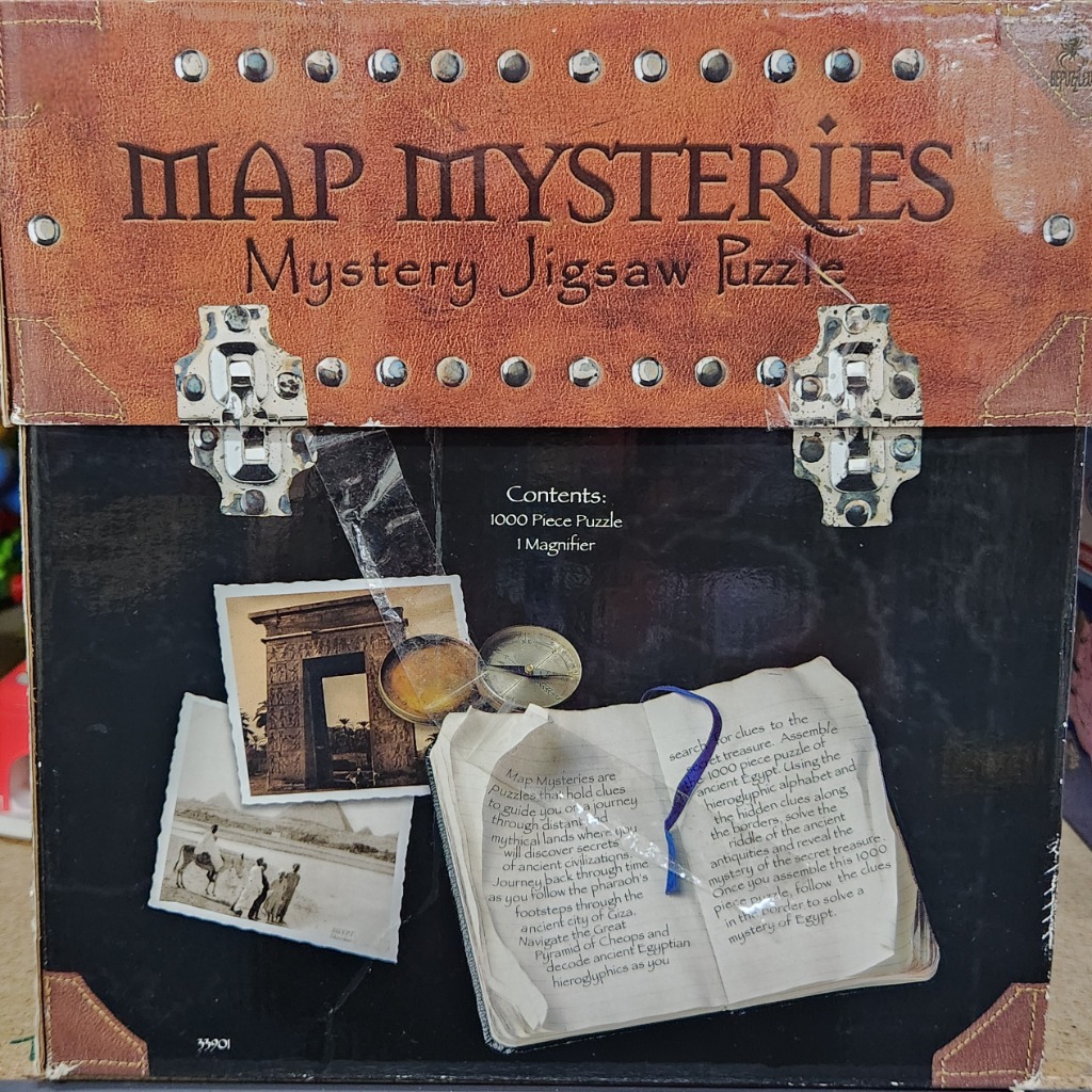 An illustrated depiction of an explorer's case containing ancient Egyptian photographs, a compass, and a notebook.