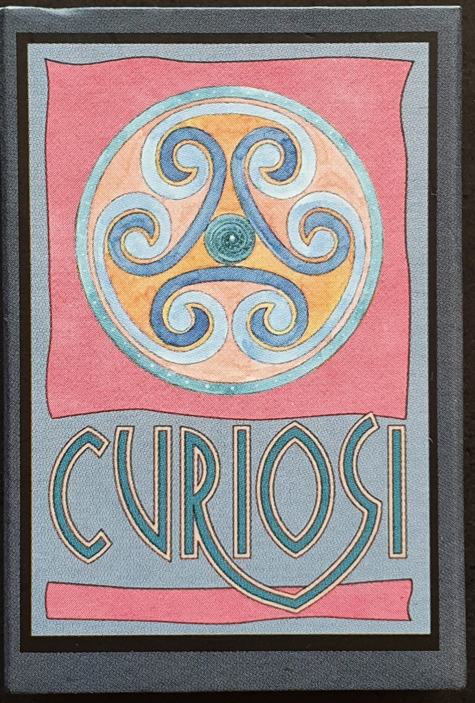 A Celtic-style triskelion symbol in a circle above the word CURIOSI on a pink and blue background.