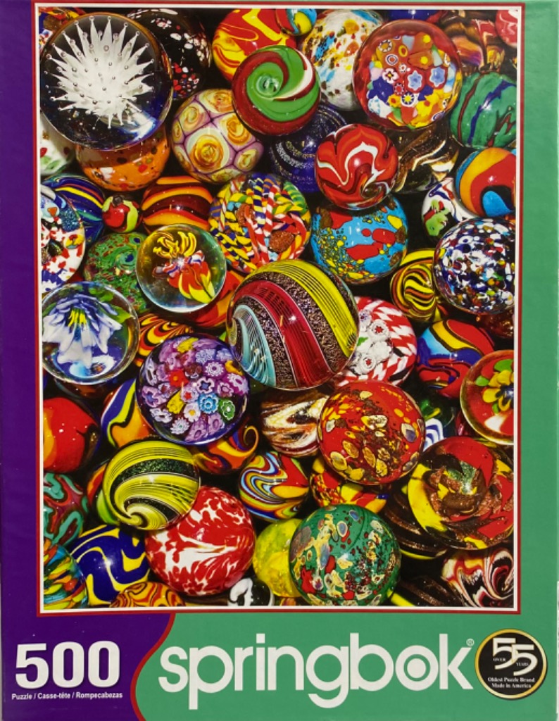A close-up collection of vibrant, multi-colored glass marbles of various patterns and designs.