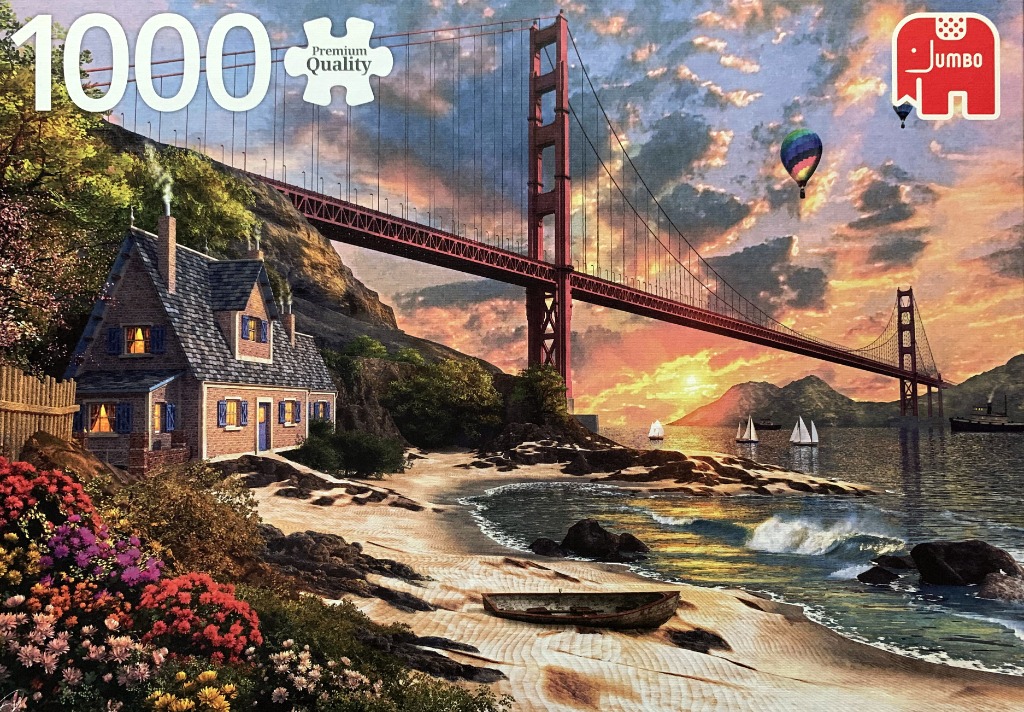 Golden Gate Bridge over a coastal cottage at sunset with hot air balloons