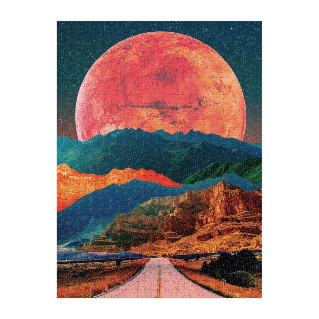 Surreal landscape featuring a giant glowing moon above colorful layered mountains and a long road leading to the horizon.