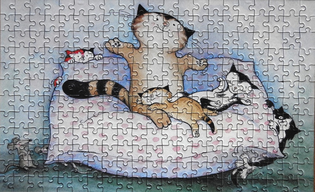 Whimsical watercolor illustration of five cats interacting on a large, polka-dotted pillow.