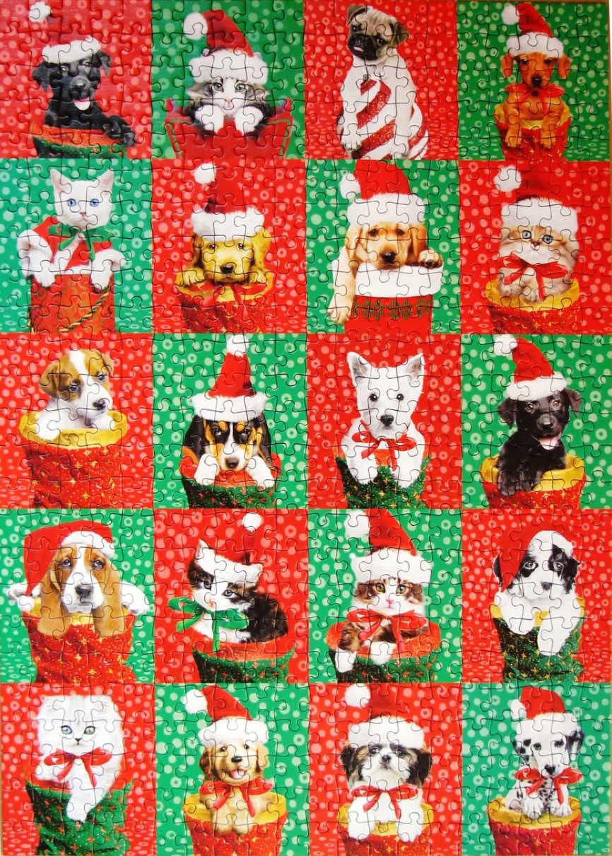 A grid of 20 festive puppies and kittens wearing Santa hats inside Christmas stockings.
