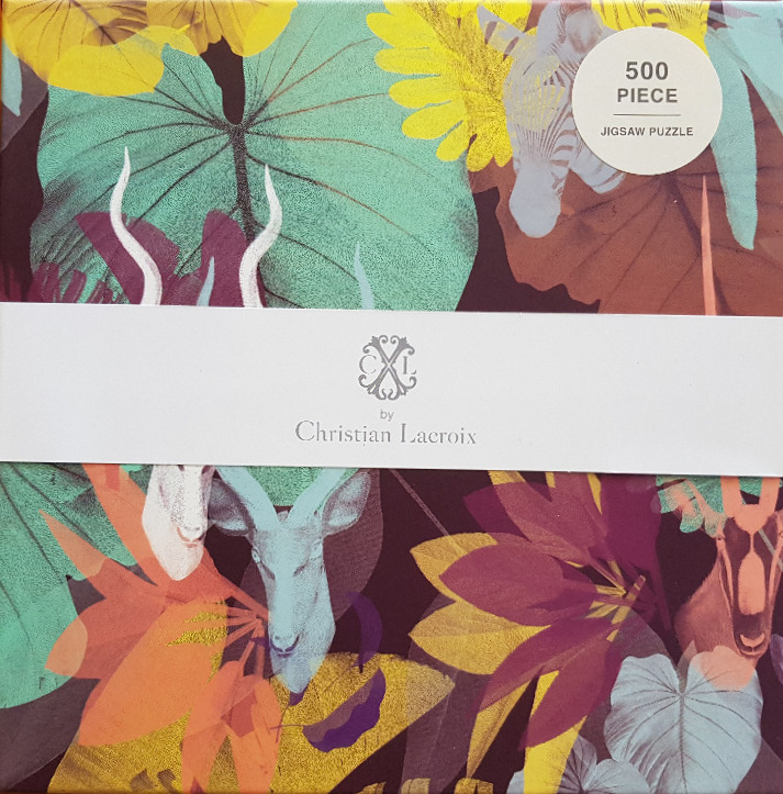 A lush jungle pattern featuring stylized animal heads hidden among large, vibrant tropical leaves.