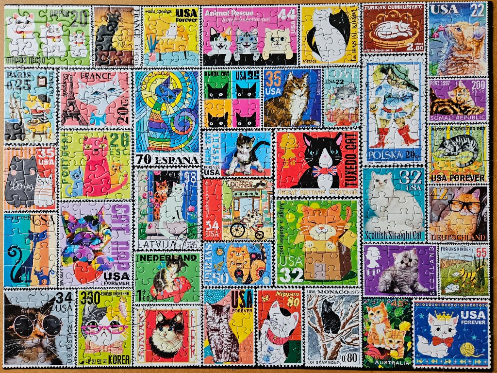 A collage of various colorful postage stamps featuring diverse cat illustrations from around the world.