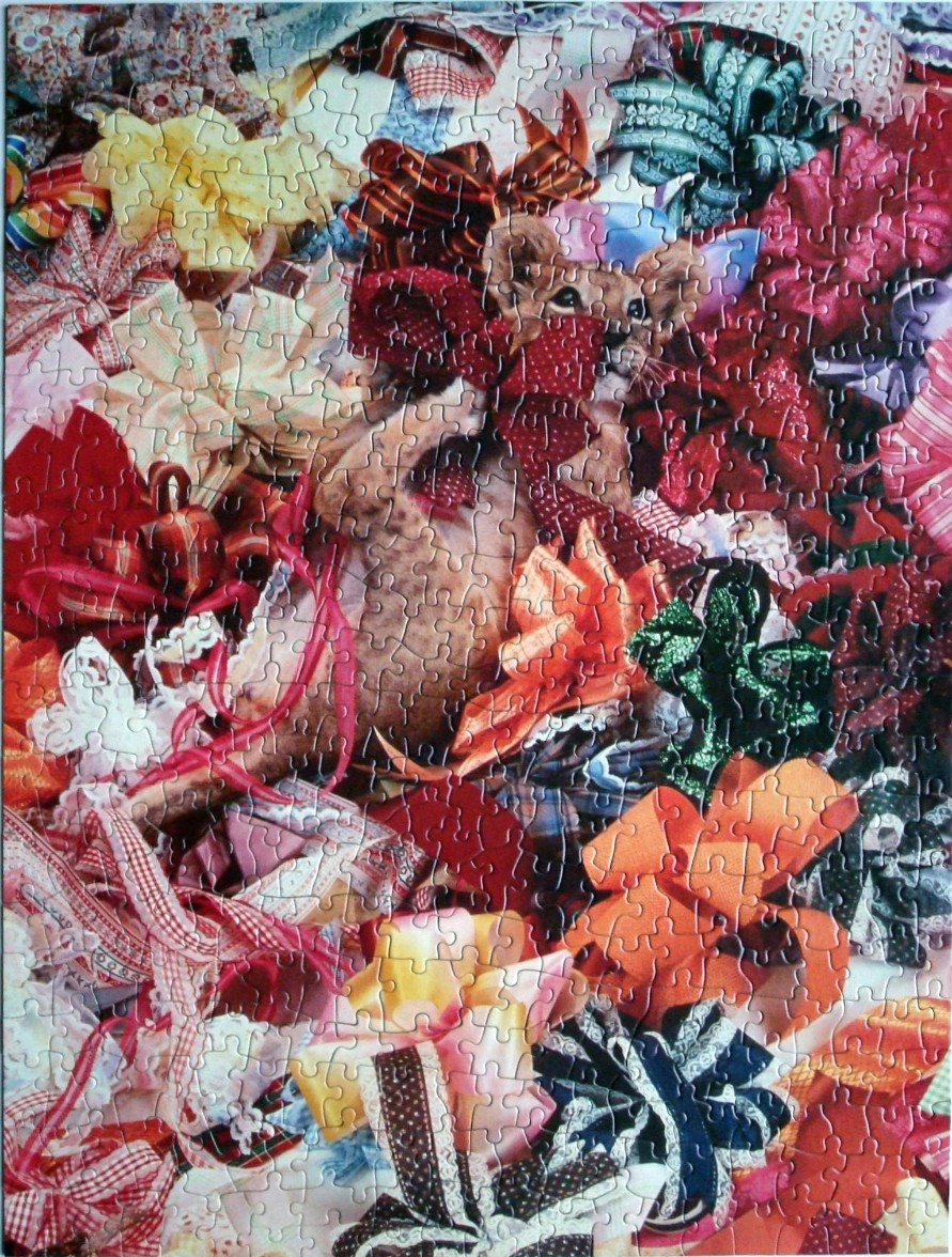 A playful lion cub surrounded by a dense, vibrant collage of colorful gift wrapping ribbons and bows.
