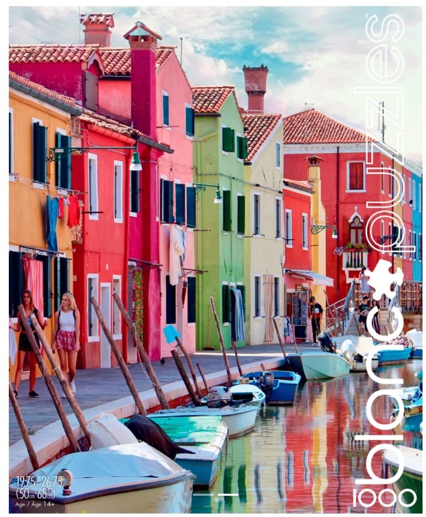 Colorful buildings and boats along a canal in Burano, Italy