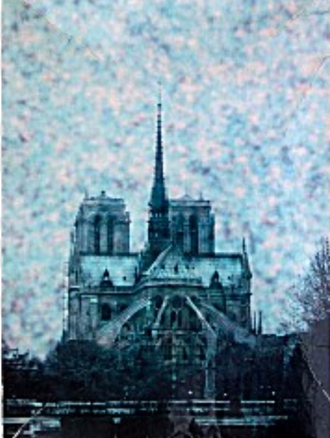 Gothic cathedral with a tall central spire set against a textured, light-flecked sky