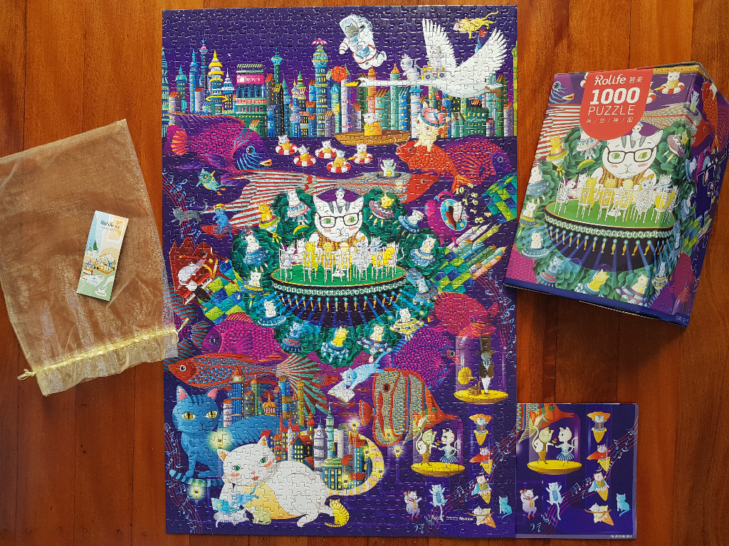 Whimsical illustration of cats in a colorful, surreal cityscape with futuristic architecture and floating fish.